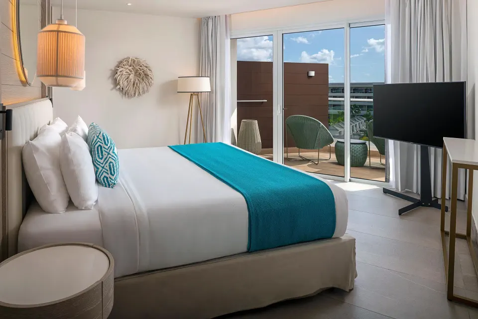 Imperial 1 Bedroom Master Suite bed facing balcony doors at Princess Grand Jamaica Resort.