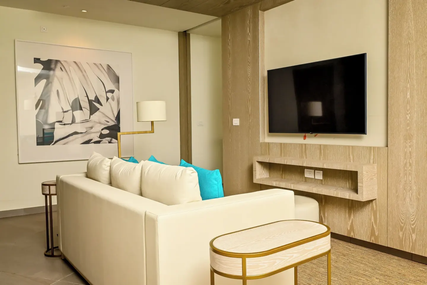 Imperial 1 Bedroom Master Suite living area with sofa and TV at Princess Grand Jamaica Resort.