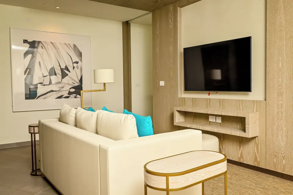 Imperial 1 Bedroom Master Suite living area with sofa and TV at Princess Grand Jamaica Resort.