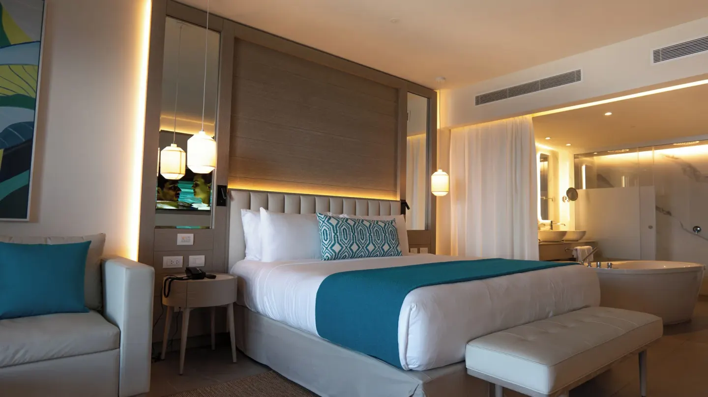 Platinum Junior Suite king bed with open bath area at Princess Grand Jamaica Resort.