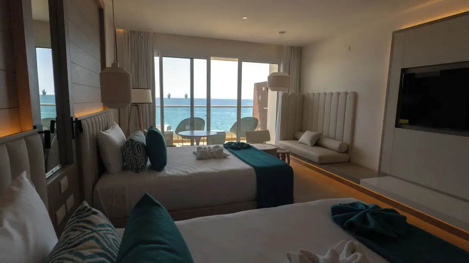 Platinum Junior Suite with two beds and ocean balcony at Princess Grand Jamaica Resort.
