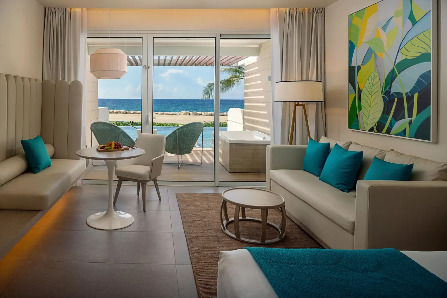 Swim Out Platinum Junior Suite seating area with terrace and ocean beyond at Princess Grand Jamaica Resort.