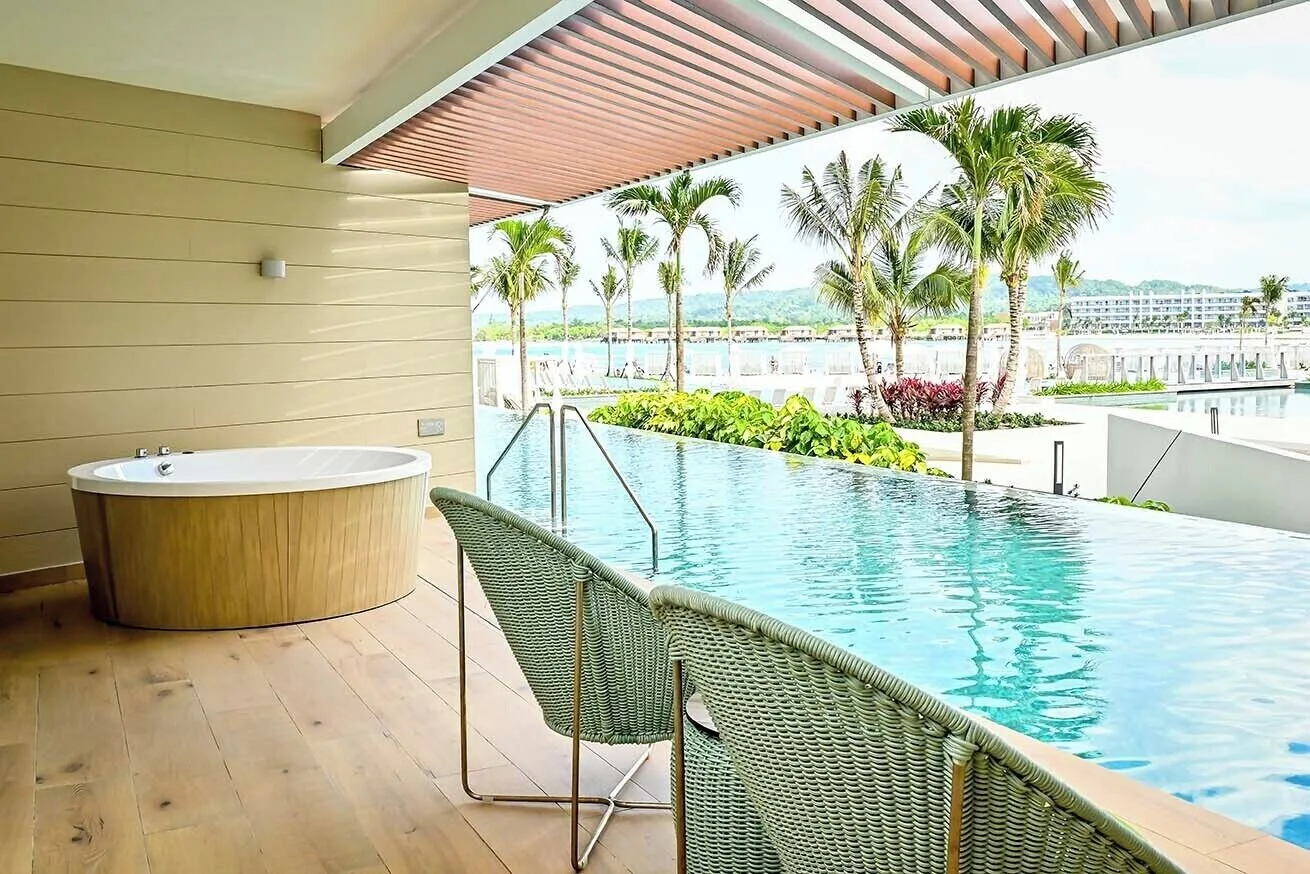 Swim Out Platinum Junior Suite terrace with pool access and outdoor tub at Princess Grand Jamaica Resort.
