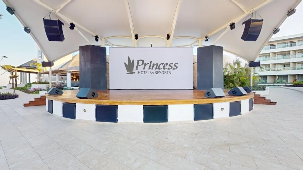 Covered outdoor stage with large screen at Princess Grand Jamaica Resort.