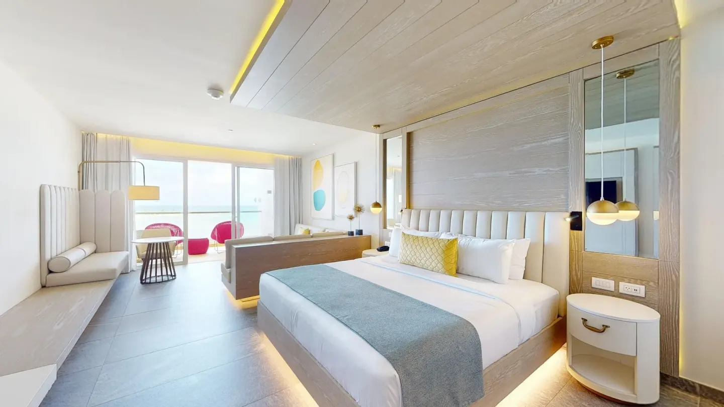 King bed guest room with seating area at Princess Senses The Mangrove Resort.