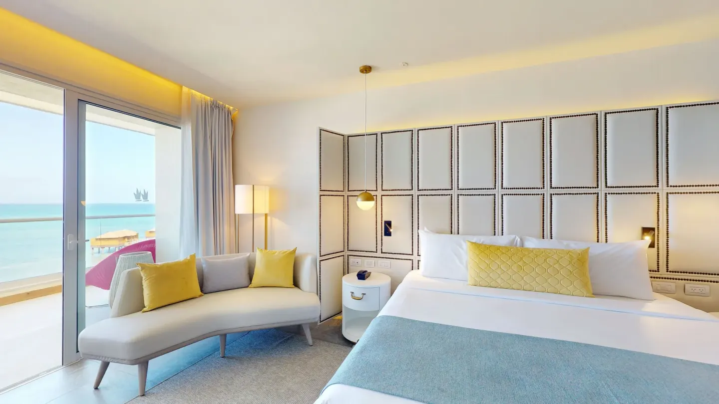 King bed guest room with ocean-facing balcony at Princess Senses The Mangrove Resort.