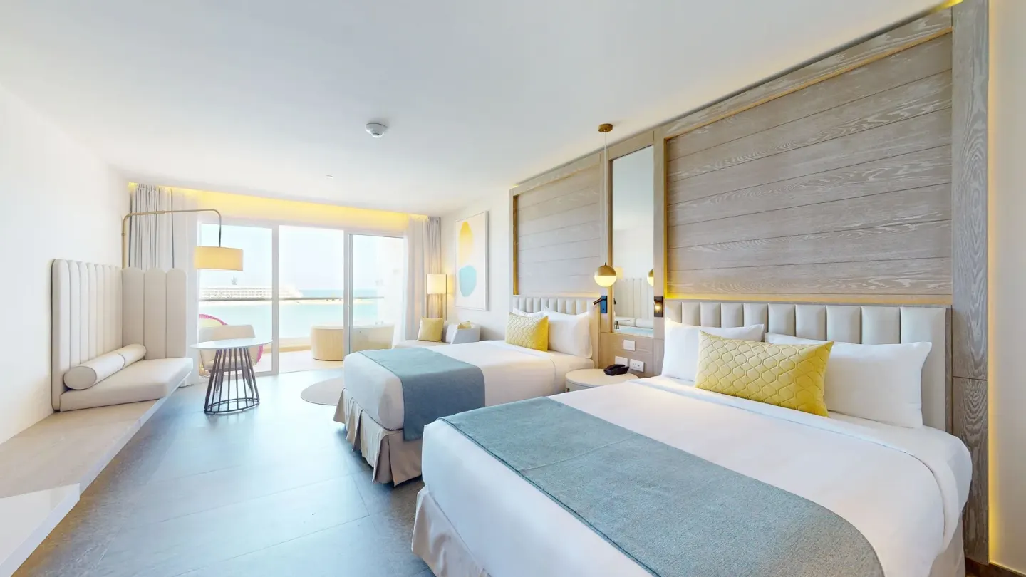 Two-bed guest room with balcony seating at Princess Senses The Mangrove Resort.
