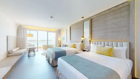 Two-bed guest room with balcony seating at Princess Senses The Mangrove Resort.
