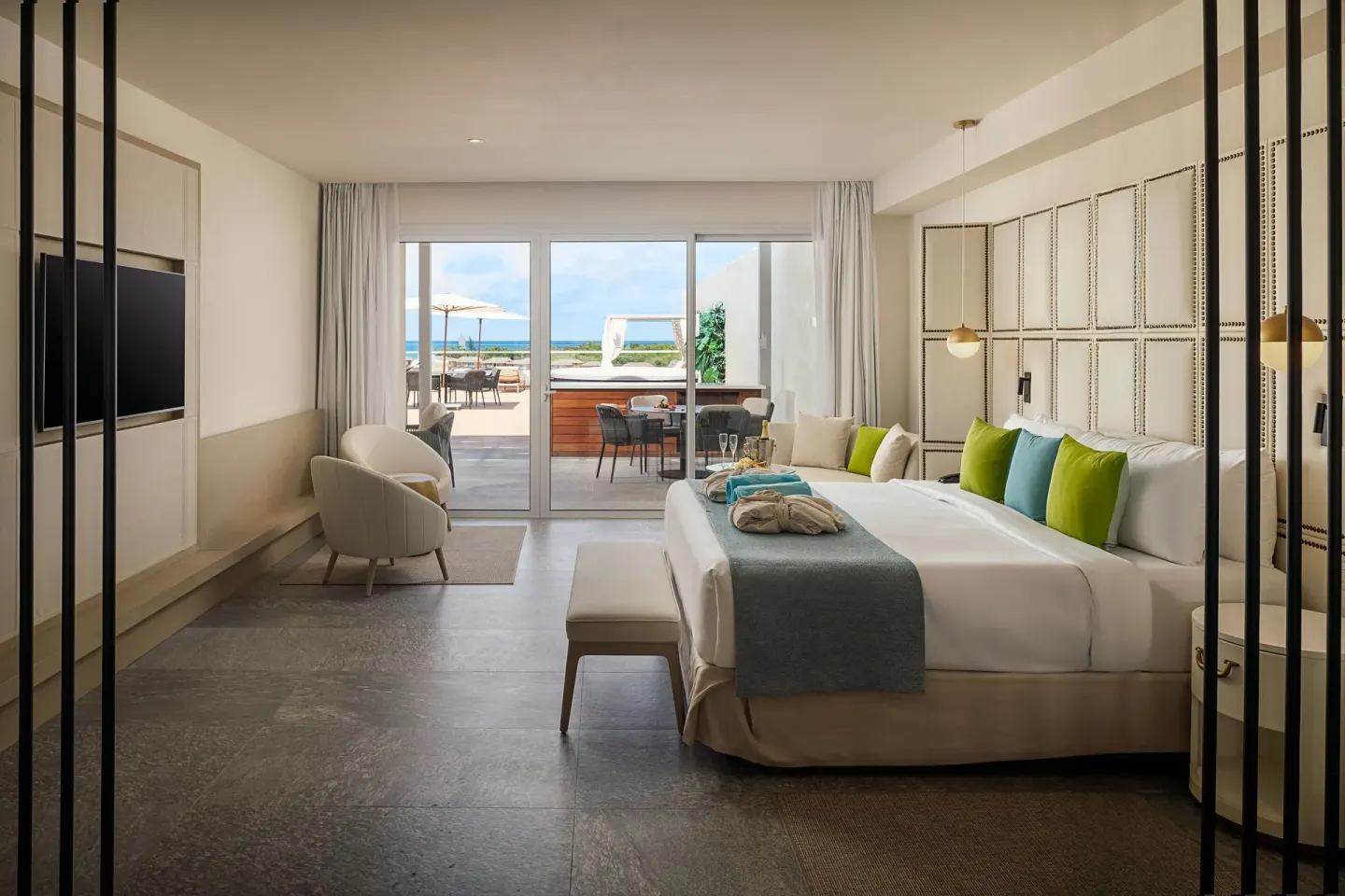 King guest room opening to a patio and ocean beyond at Princess Senses The Mangrove Resort.