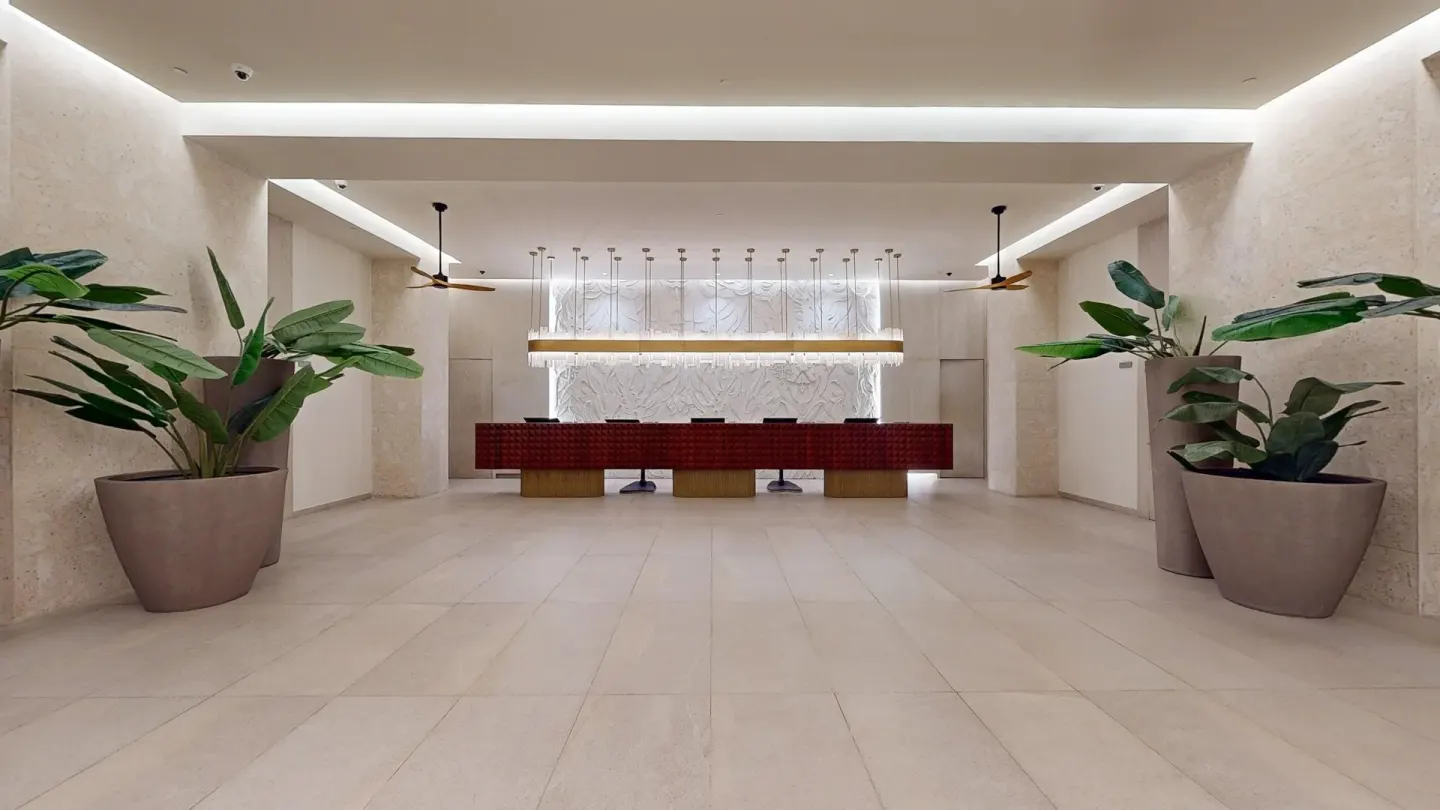 Reception desk and potted plants in the lobby at Princess Senses The Mangrove Resort.