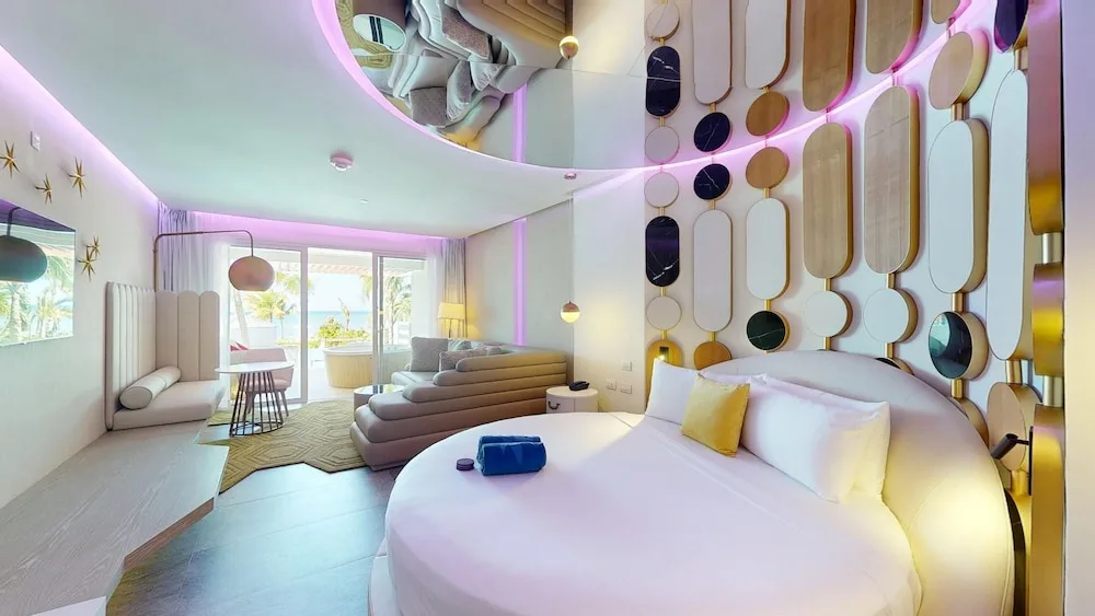 Round-bed guest room with colorful wall panels at Princess Senses The Mangrove Resort.