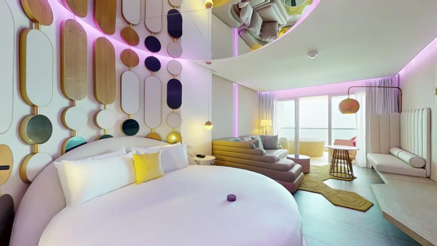 Round bed suite with lounge seating and balcony at Princess Senses The Mangrove Resort.