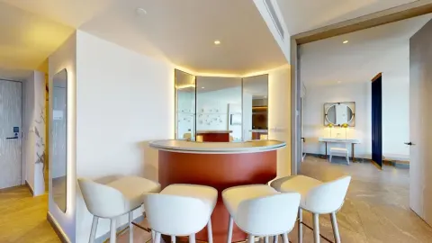 In-room bar counter with stools in a suite at Princess Senses The Mangrove Resort.