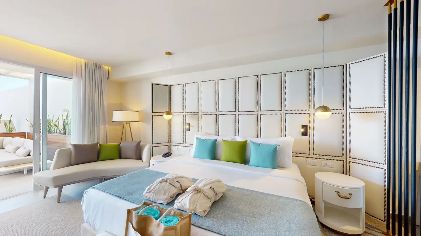 King bed with chaise lounge and balcony access at Princess Senses The Mangrove Resort.