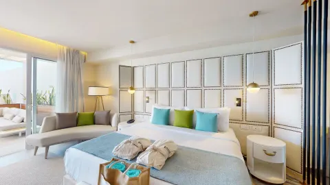 King bed with chaise lounge and balcony access at Princess Senses The Mangrove Resort.