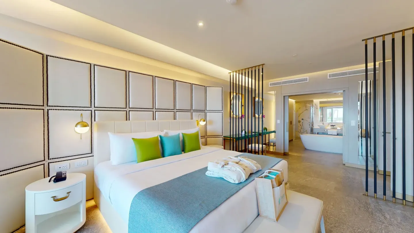 King bed and open bathroom in a suite at Princess Senses The Mangrove Resort.
