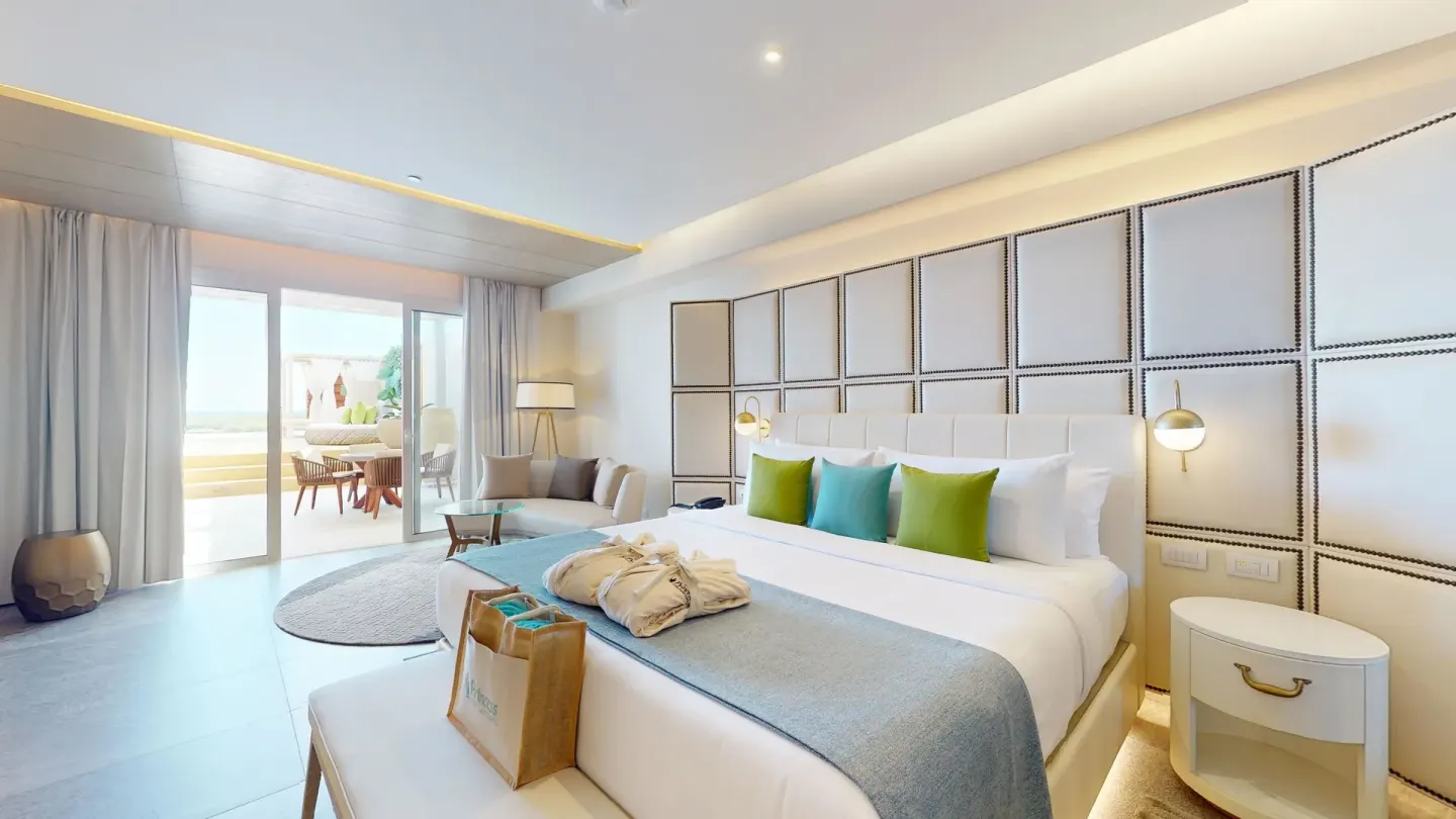 King bed, sitting area, and terrace doors at Princess Senses The Mangrove Resort.