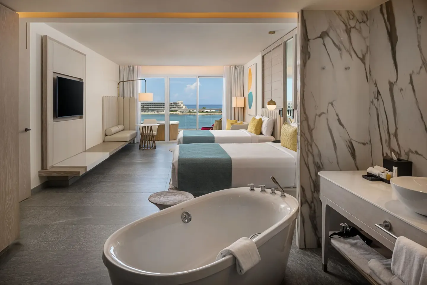 Twin-bed room with freestanding bathtub at Princess Senses The Mangrove Resort.