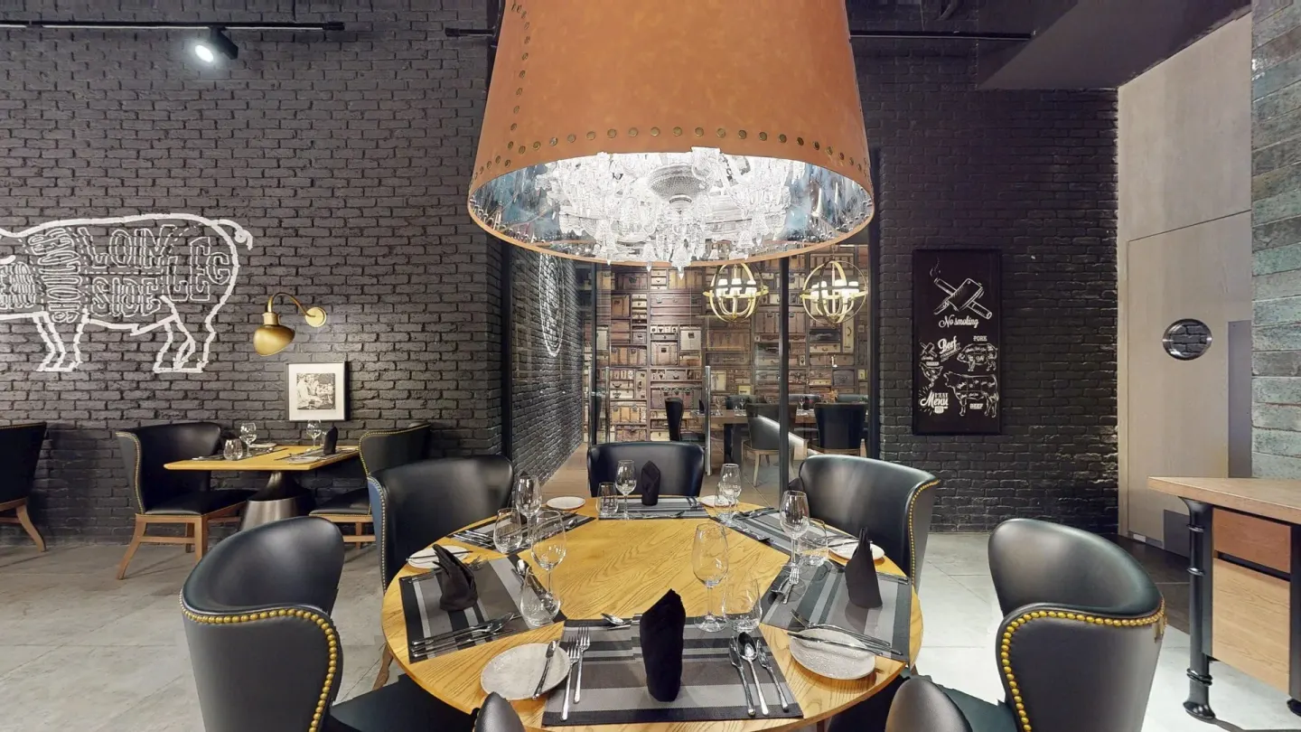 Steakhouse dining room with round table at Princess Senses The Mangrove Resort.