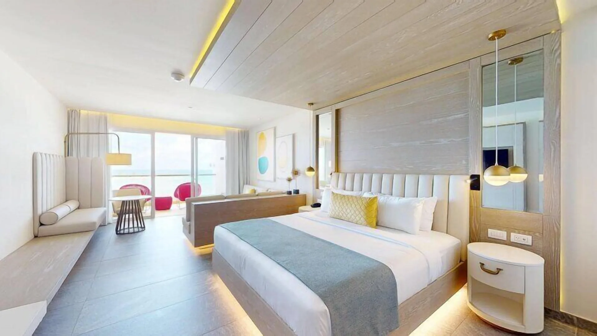Deluxe Junior Suite king bed and lounge area at Princess Senses The Mangrove Resort.