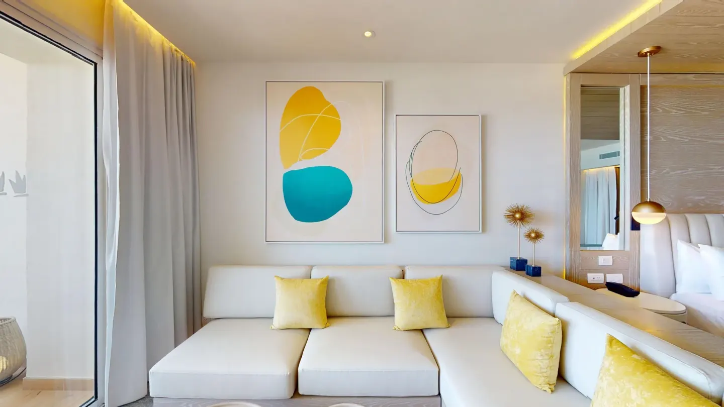 Deluxe Junior Suite sofa and wall art at Princess Senses The Mangrove Resort.
