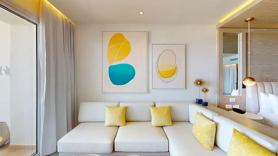 Deluxe Junior Suite sofa and wall art at Princess Senses The Mangrove Resort.