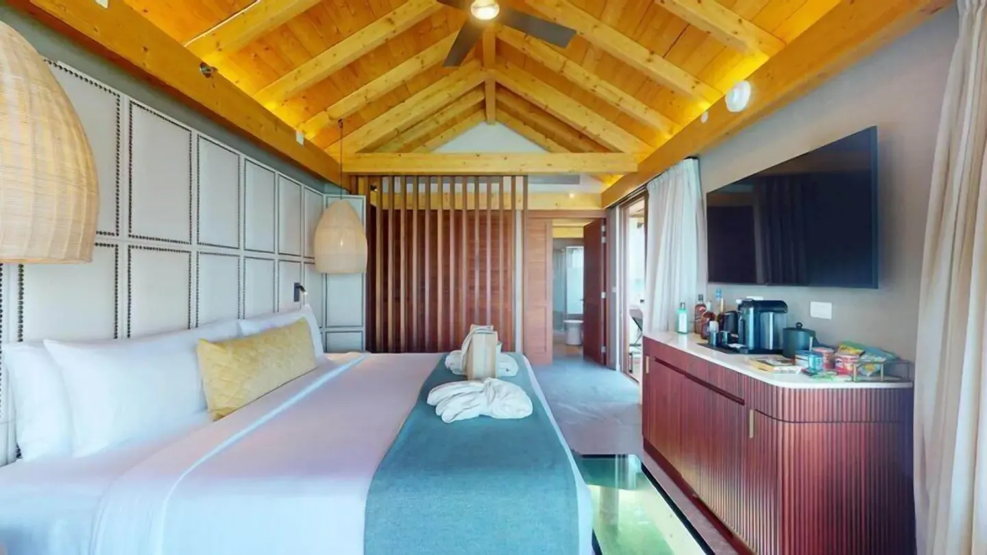 King bed and vaulted ceiling in an Overwater Villa at Princess Senses The Mangrove Resort.