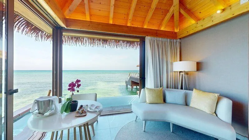 Sitting area by the infinity pool in an Overwater Villa at Princess Senses The Mangrove Resort.