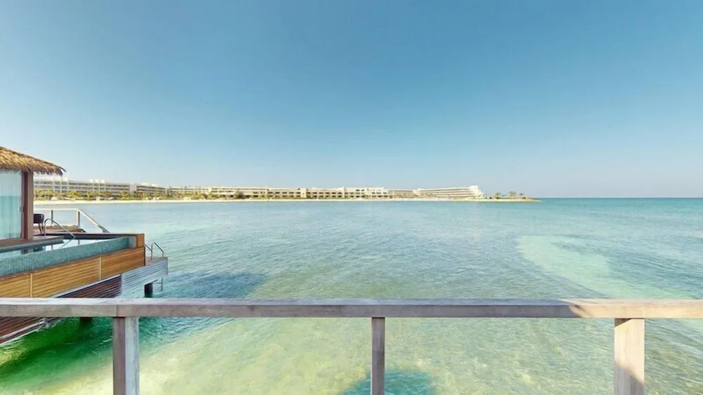 Overwater Villa deck view across clear water at Princess Senses The Mangrove Resort.