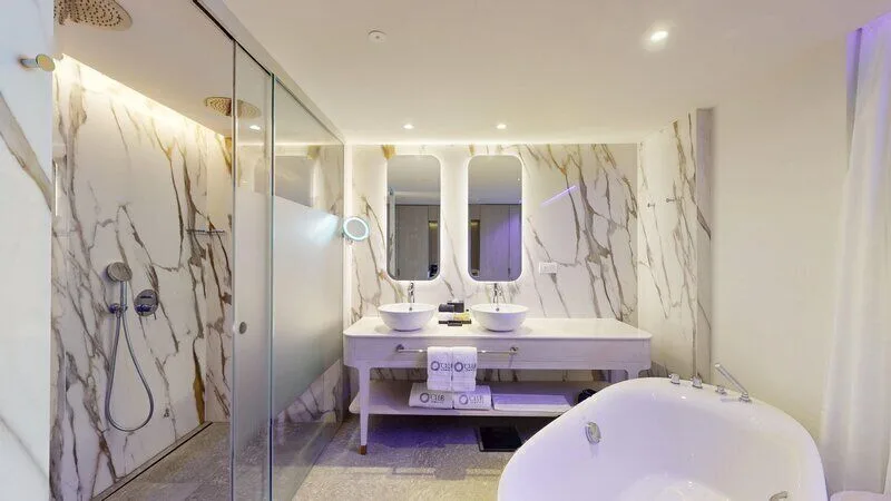 Pleasure Junior Suite bathroom with tub and double sinks at Princess Senses The Mangrove Resort.