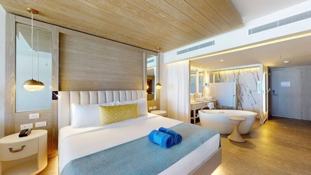 Swim Out Deluxe Junior Suite king bed and open bath at Princess Senses The Mangrove Resort.