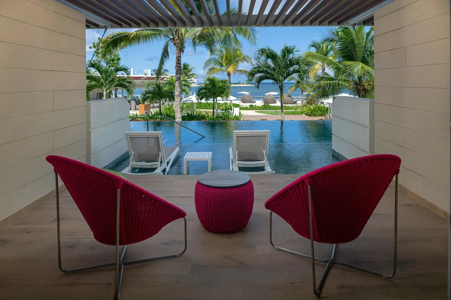 Swim-out terrace with red chairs and pool at Princess Senses The Mangrove Resort.