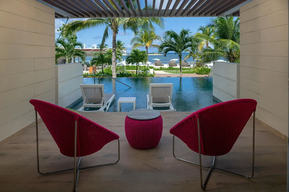 Swim-out terrace with red chairs and pool at Princess Senses The Mangrove Resort.
