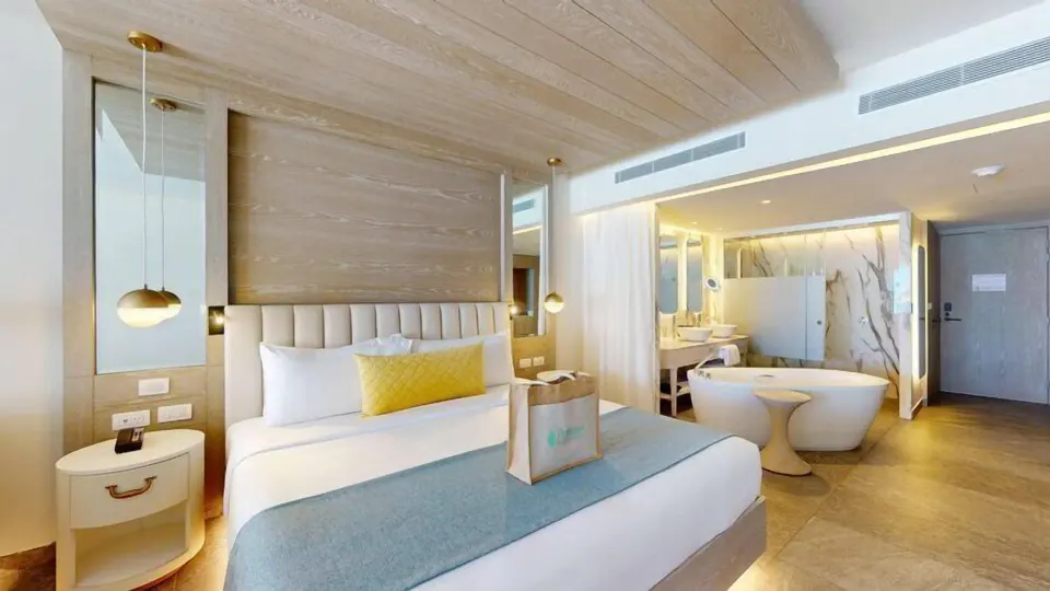 King bed and open bathroom in a Swim Out Platinum Junior Suite at Princess Senses The Mangrove Resort.