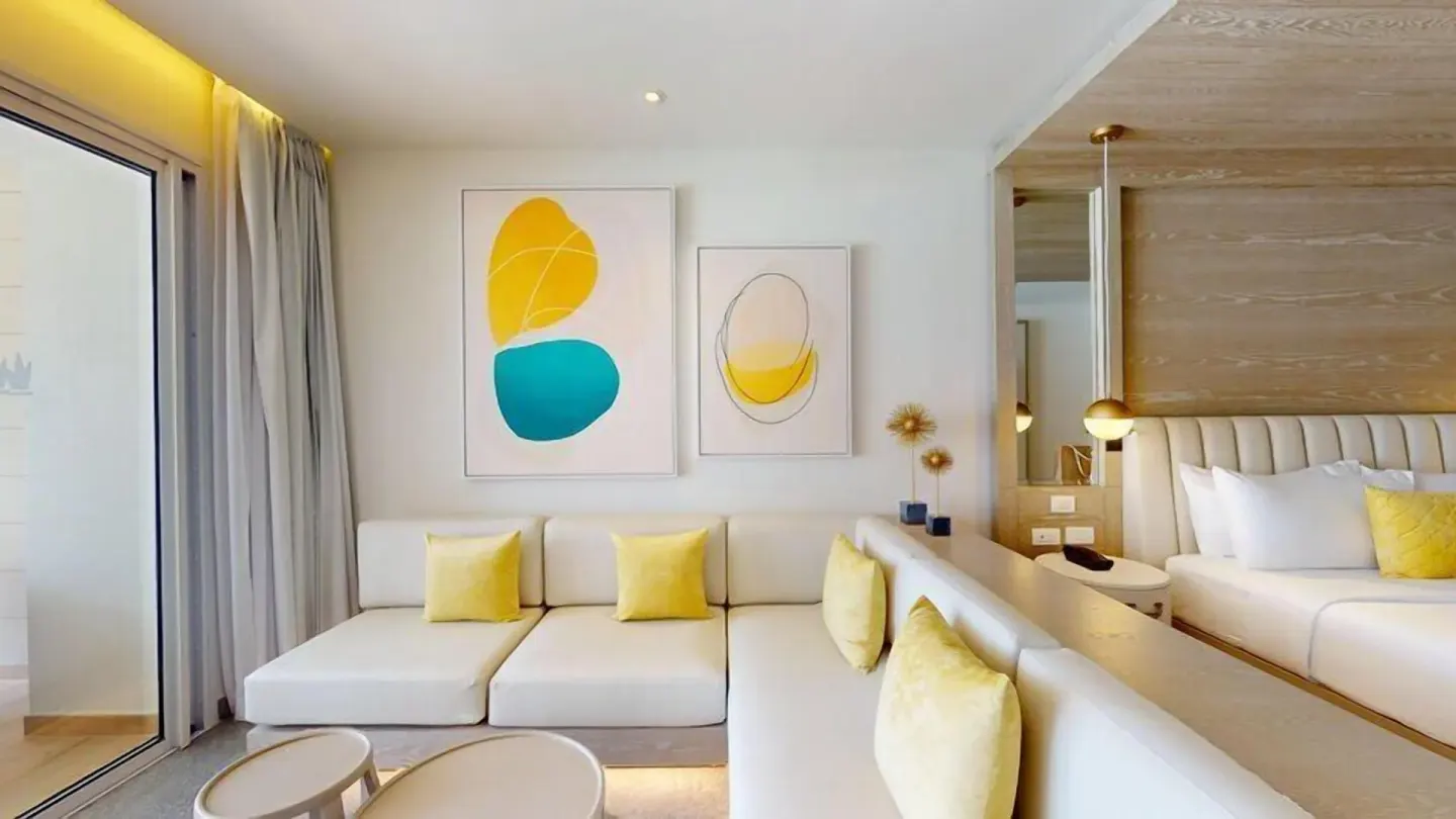 Lounge seating beside the king bed in a Swim Out Platinum Junior Suite at Princess Senses The Mangrove Resort.