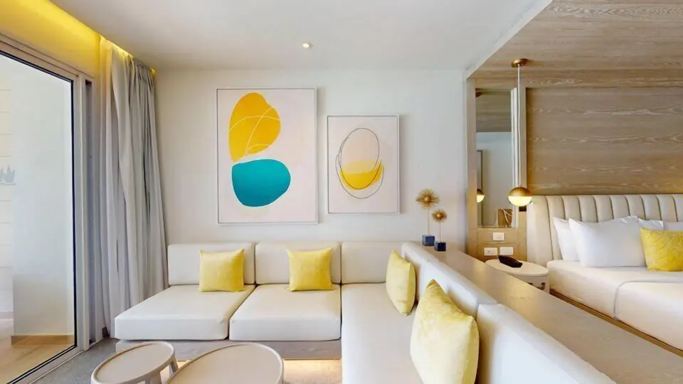 Lounge seating beside the king bed in a Swim Out Platinum Junior Suite at Princess Senses The Mangrove Resort.