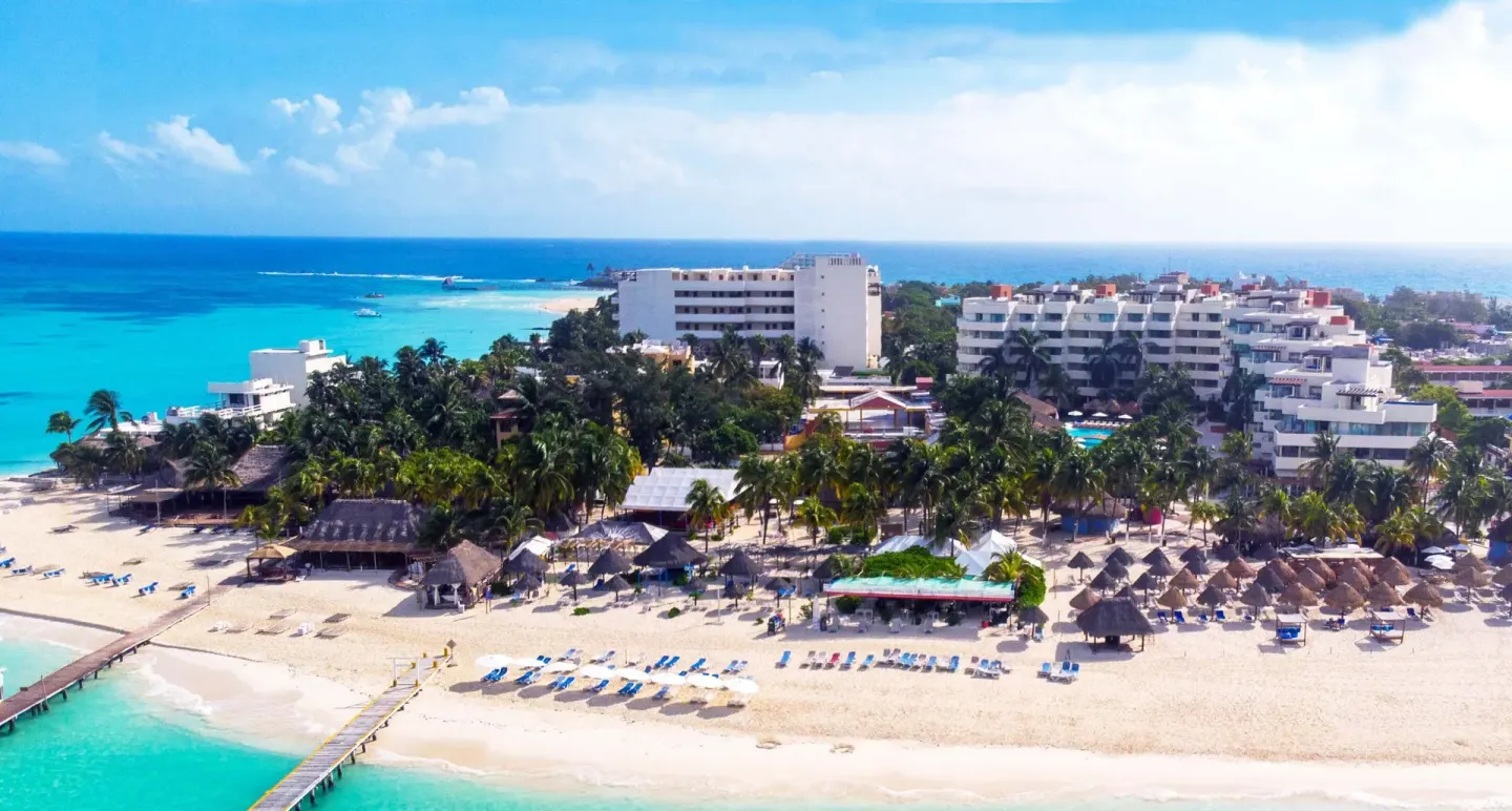 Aerial view of the beachfront and resort buildings at Privilege Aluxes Isla Mujeres.