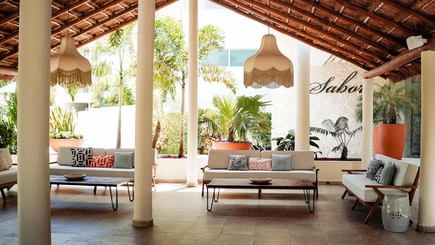 Covered lounge seating beside Sabor at Privilege Aluxes Isla Mujeres.
