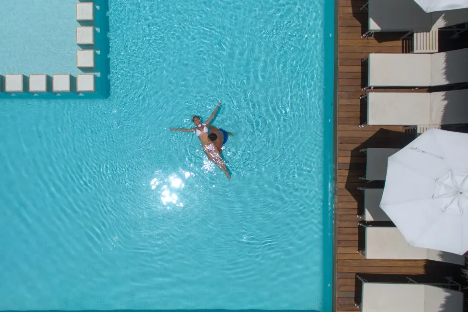 Overhead view of a swimmer in the pool at Privilege Aluxes Isla Mujeres.