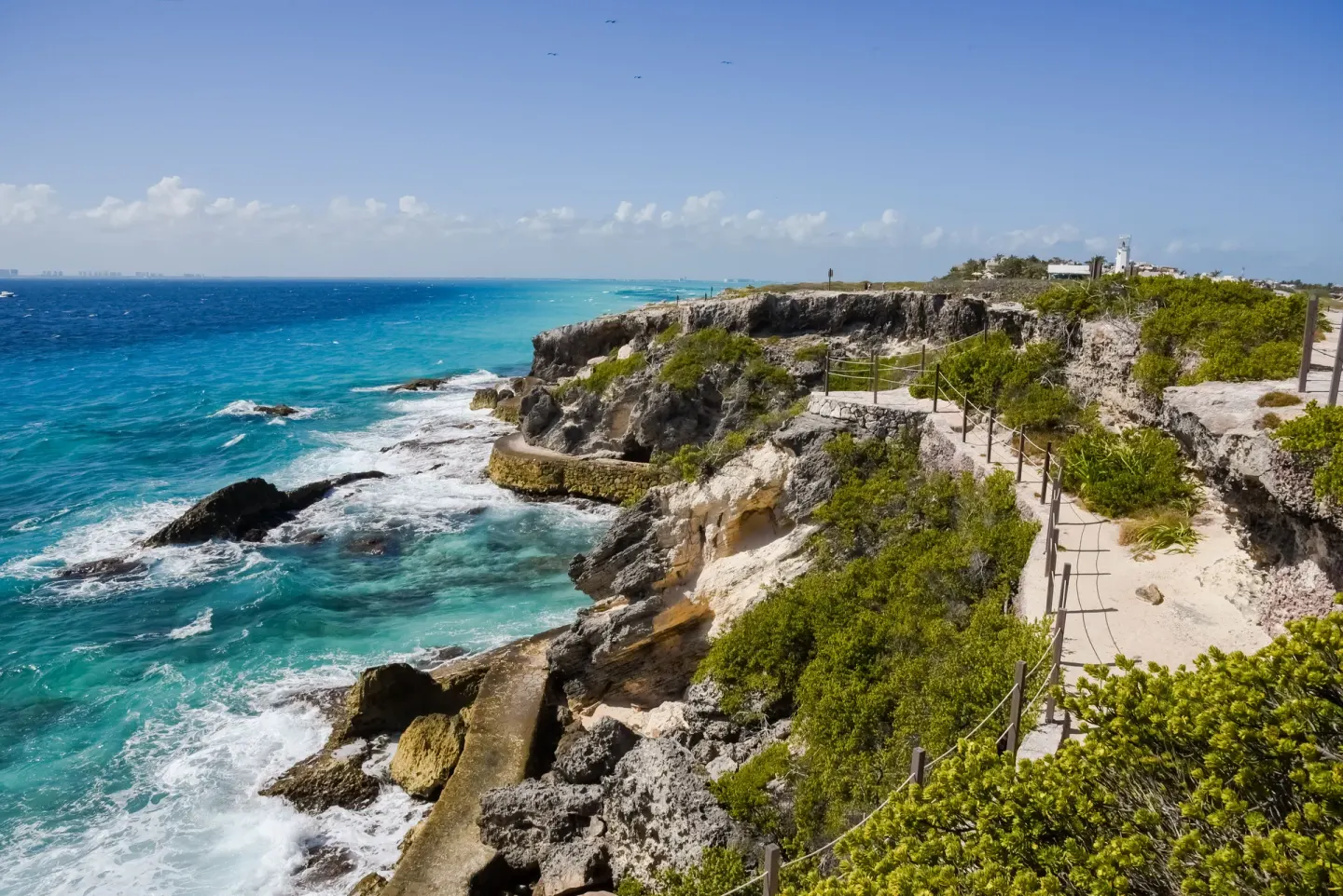 Rocky coastline and cliffside path near Privilege Aluxes Isla Mujeres.
