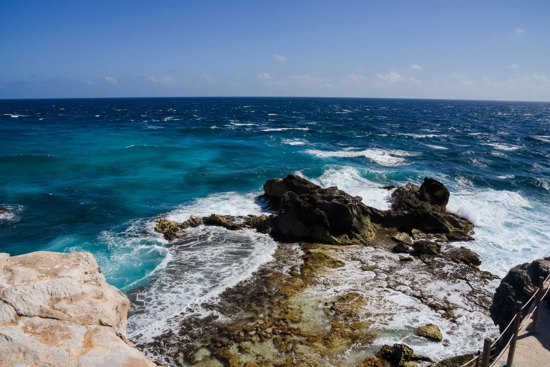 Rocky shore and waves along the coast near Privilege Aluxes Isla Mujeres.