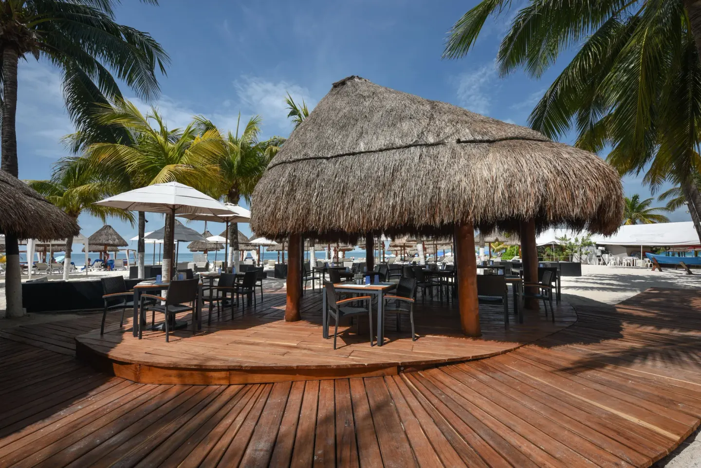 Thatched beachside seating area at Privilege Aluxes Isla Mujeres.