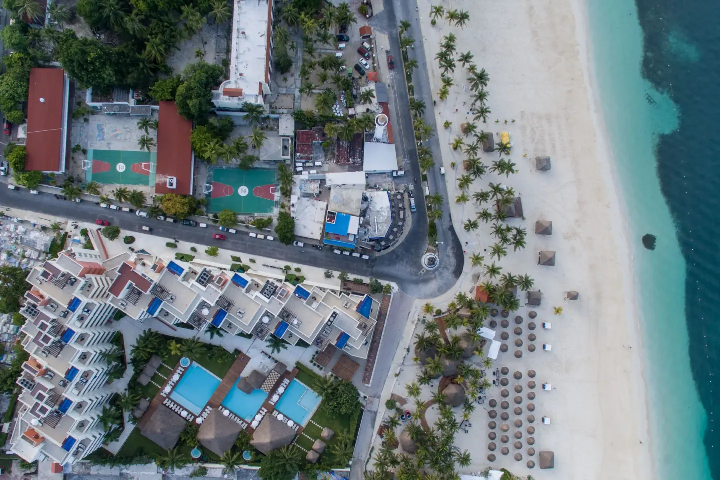 Top-down aerial view of Privilege Aluxes Isla Mujeres beside the beach and shoreline.