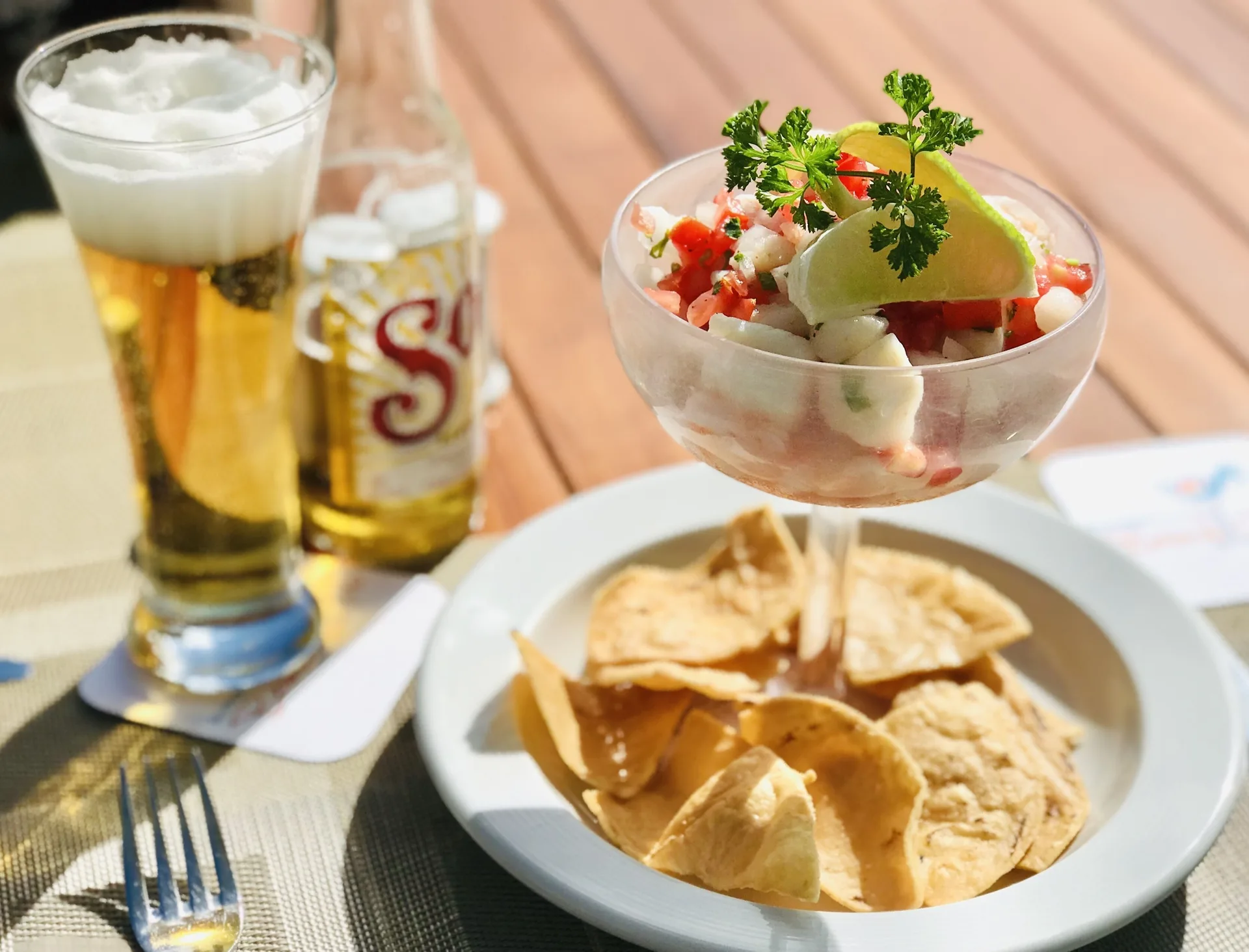 Ceviche with chips and beer on a table at Privilege Aluxes Isla Mujeres.