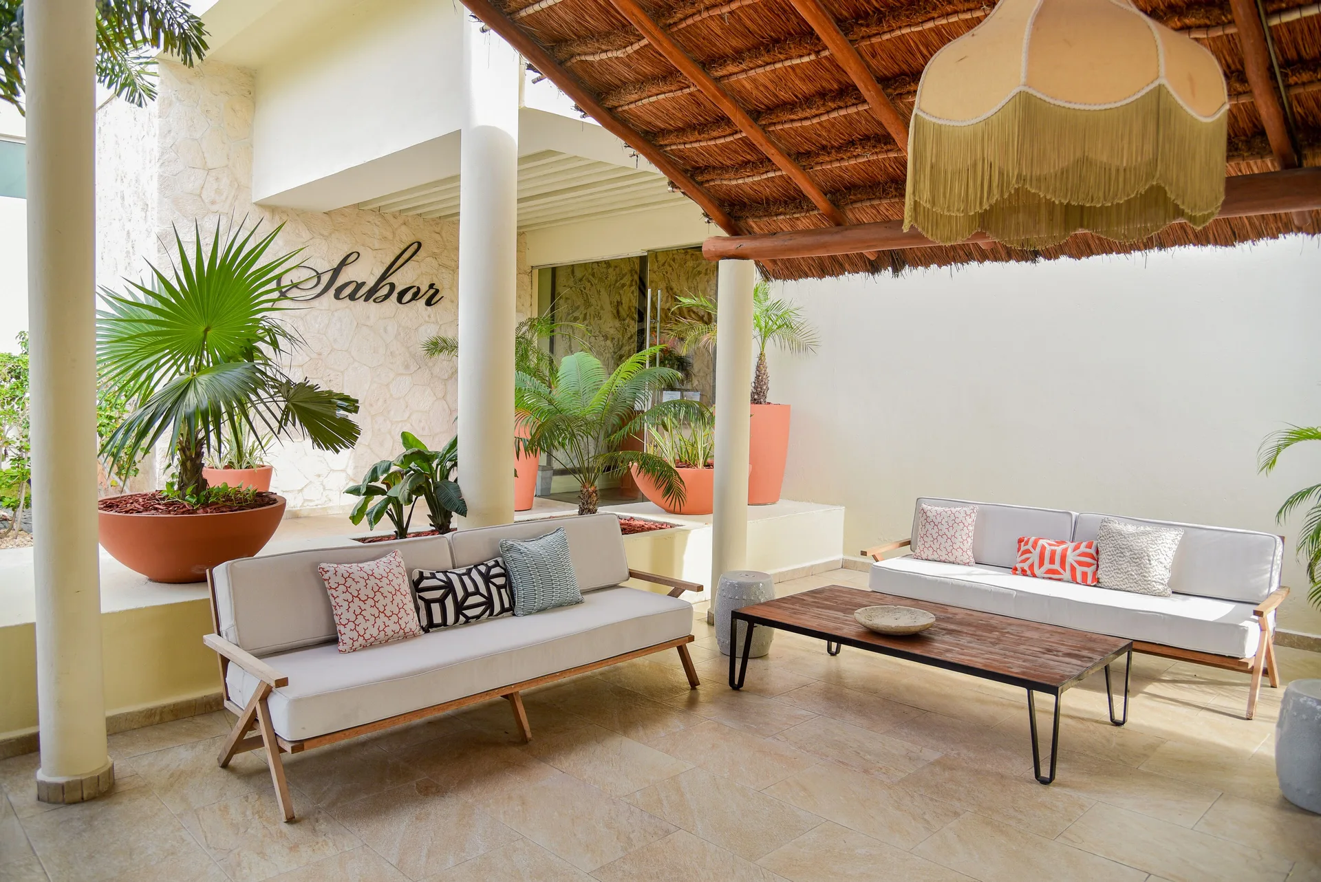Covered lounge seating outside Sabor at Privilege Aluxes Isla Mujeres.