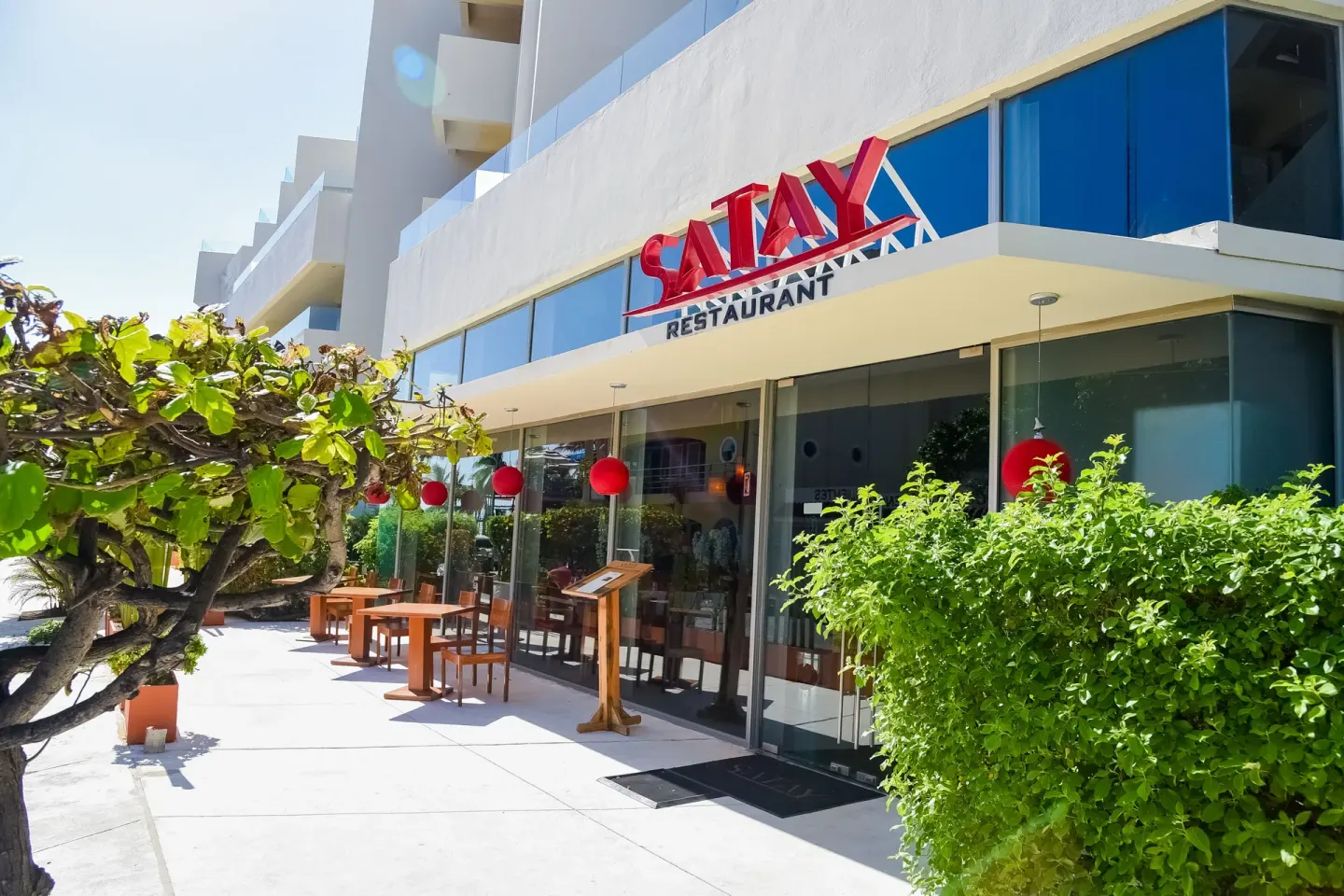 Satay restaurant entrance with red signage at Privilege Aluxes Isla Mujeres.