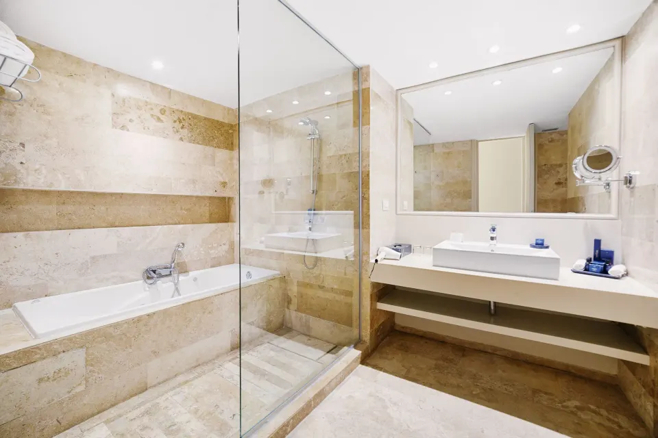 Deluxe Suite Garden View bathroom with tub and shower at Privilege Aluxes Isla Mujeres.