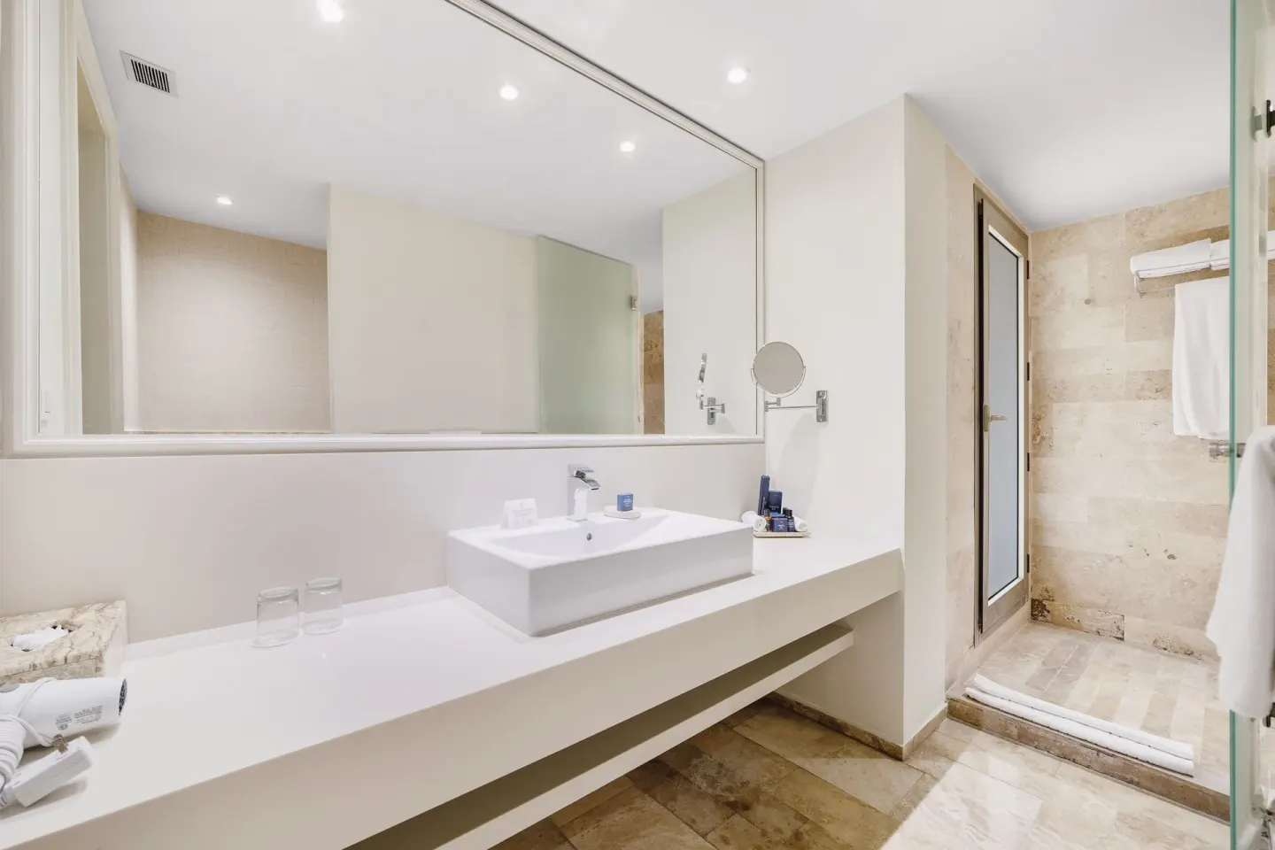 Deluxe Suite Garden View bathroom vanity and shower at Privilege Aluxes Isla Mujeres.