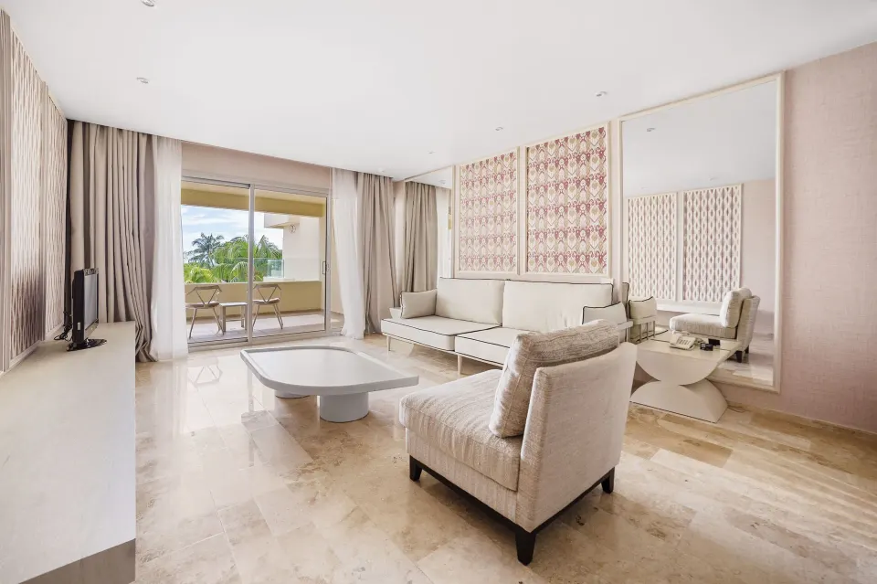 Deluxe Suite Garden View living area with balcony at Privilege Aluxes Isla Mujeres.