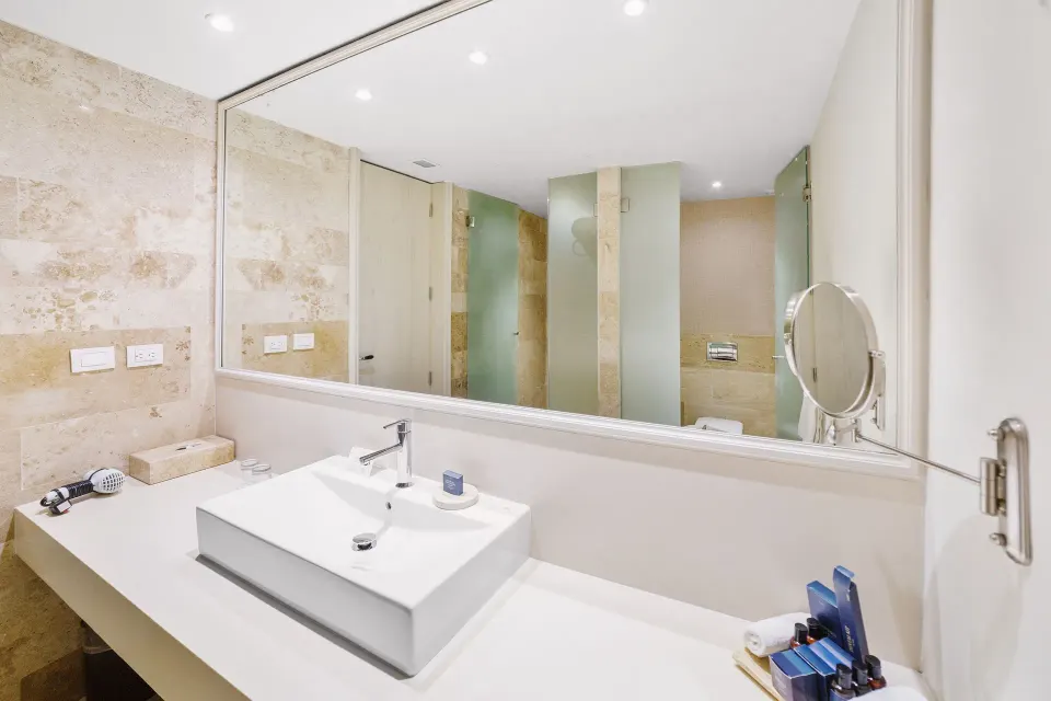 Premium Suite bathroom vanity with large mirror at Privilege Aluxes Isla Mujeres.